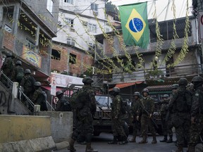 Soldiers patrol the Chapeu Mangueira slum of Rio de Janeiro, Brazil, Thursday, June 21, 2018. Many Brazilians look to the military amid anger at politicians, believing only the armed forces can root out corruption and put Latin America's largest nation back on track.