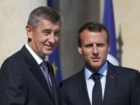 France President Emmanuel Macron, right, welcomes Czech Prime Minister Andrej Babis prior to a meeting, at the Elysee Palace, in Paris, Saturday, June 30, 2018.