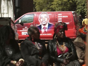 Supporters of Zimbabwes main oppositon leader, Nelson Chamisa are seen close to his campaign vehicle outside the magistrates courts in Harare, Thursday, June, 14, 2018.Zimbabwes military backed president and a youthful opposition leader, Nelson Chamisa have registered for July 30 elections, the first without former Leader Robert Mugabe's participation.