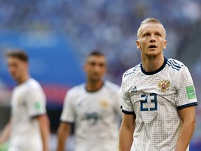 Russia's Igor Smolnikov leaves the pitch after receiving the red card during the group A match between Uruguay and Russia at the 2018 soccer World Cup at the Samara Arena in Samara, Russia, Monday, June 25, 2018.