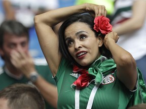 A Mexico fan pins a flower into her hair before the group F match between Mexico and South Korea at the 2018 soccer World Cup in the Rostov Arena in Rostov-on-Don, Russia, Saturday, June 23, 2018.