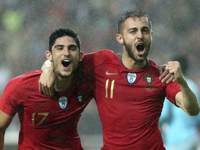 Portugal's Bernardo Silva, right, celebrates with Portugal's Goncalo Guedes after scoring his team opening goal during a friendly soccer match between Portugal and Algeria in Lisbon, Portugal, Thursday, June 7, 2018.