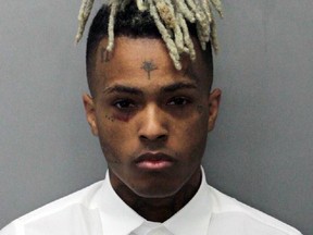 This 2017 arrest photo made available by the Miami Dade Dept. of Corrections shows Jahseh Onfroy, also known as the rapper XXXTentacion, under arrest. Onfroy was shot and killed, Monday, June 18, 2018, in Deerfield Beach, Fla.