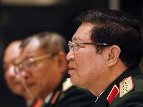 Vietnam's Defense Minister Ngo Xuan Lich, right, speaks during a bilateral meeting with U.S. Defense Secretary Jim Mattis at the International Institute for Strategic Studies (IISS) Shangri-la Dialogue, an annual defense and security forum in Asia, in Singapore, Friday, June 1, 2018.