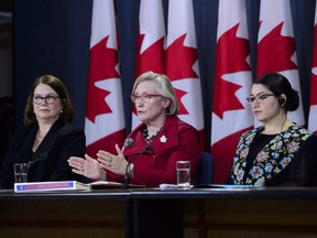 Carolyn Bennett, minister of Crown-Indigenous relations and northern affairs, speaks as she is joined by Jane Philpott, minister of Indigenous services, left, and Maryam Monsef, minister for the status of women, during a press conference at a National Press Theatre in Ottawa on Tuesday, June 5, 2018.