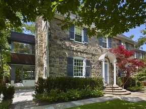 The modern addition blends beautifully with the classic stone home.