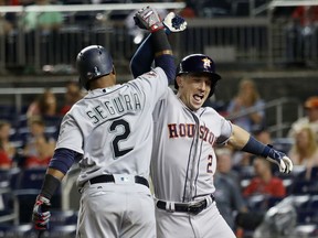 Alex Bregman of the Houston Astros and the American League celebrates with Jean Segura of the Seattle Mariners after hitting a solo home run in the 10th inning against the National League during the 89th MLB All-Star Game at Nationals Park in Washington on Tuesday night.