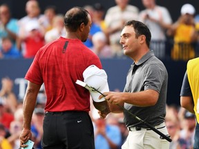 Francesco Molinari of Italy (R) is congratulated by Tiger Woods of the United States after a birdie on the 18th hole during the final round of the 147th Open Championship at Carnoustie Golf Club on July 22, 2018 in Carnoustie, Scotland.