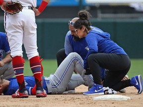 Lourdes Gurriel Jr. of the Toronto Blue Jays is examined by trainers after suffering an apparent leg injury in the 9th inning against the White Sox at Guaranteed Rate Field on Sunday in Chicago. The Blue Jays won 7-4.