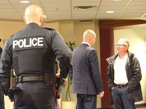 St. Catharines Standard reporter Bill Sawchuk, right, is addressed by Niagara Region senior staffer Chris Carter while being ejected from regional council chambers and removed from the property under police escort.