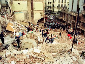 People gather at the site of a bombing at the Asociacio Mutual Israelita Argentina (AMIA) Jewish community center in Buenos Aires, Argentina, on July 18, 1994.