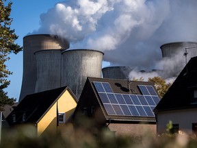 Steam rises from the Niederaussem coal-fired power plant operated by German utility RWE, which stands near open-pit coal mines that feed it with coal, on November 13, 2017 near Bergheim, Germany.