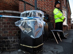 A police officer stands at a cordon around a public litter bin next to a supported housing project in Salisbury after a major incident was declared when a man and woman were exposed to the Novichok nerve agent on July 5, 2018 in Salisbury, England.