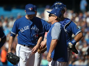 J.A. Happ of the Blue Jays exits the game as he is relieved by manager John Gibbons in the third inning of their game against the New York Yankees at Rogers Centre in Toronto on Saturday.