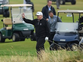 TURNBERRY, SCOTLAND - JULY 15:  U.S. President Donald Trump waves whilst playing a round of golf at Trump Turnberry Luxury Collection Resort during the U.S. President's first official visit to the United Kingdom on July 15, 2018 in Turnberry, Scotland. The President of the United States and First Lady, Melania Trump on their first official visit to the UK after yesterday's meetings with the Prime Minister and the Queen is in Scotland for private weekend stay at his Turnberry.  (Photo by Leon Neal/Getty Images)
