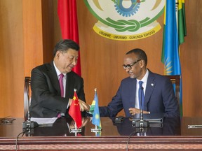 China's President Xi Jinping, left, shakes hands with Rwanda's President Paul Kagame during a press conference at State House, in Kigali, Rwanda, Monday, July 23, 2018. Kagame is praising China's treatment of Africa "as an equal," calling it "a revolutionary posture in world affairs."