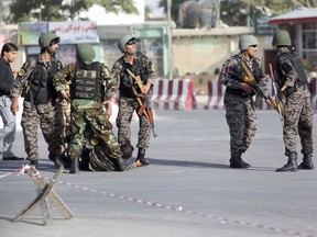 Afghan security personnel arrive to the site of an attack near the Kabul Airport, in Kabul, Afghanistan, Sunday, July 22, 2018. An Afghan spokesman says there has been a large explosion near the Kabul airport shortly after the country's controversial first vice president landed on his return from abroad. Gen. Abdul Rashid Dostum and members of his entourage were unharmed in the explosion on Sunday, which took place as his convoy had already left the airport