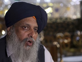 FILE - In this May 30, 2018 file photo, Avtar Singh Khalsa, a Sikh and longtime leader of the community, gives an interview to the Associated Press, in Kabul, Afghanistan. On Sunday, July 1, 2018, a suicide bomber targeted a group of Sikhs and Hindus on their way to meet Afghanistan's president in the eastern city of Jalalabad, killing at least 19 people including  Khalsa, who had planned to run in the parliamentary elections set for October.