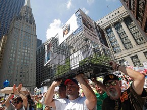 Protestors hold up an animal cage during a demonstration against U.S. immigration policies separating migrant families in Chicago, June 30, 2018.