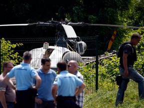 This picture taken on July 1, 2018 in Gonesse, north of Paris shows police near a French helicopter Alouette II abandoned by French armed robber Redoine Faid after his escape from prison in Reau.
