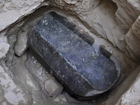 This picture released on July 1, 2018, by the Egyptian Ministry of Antiquities shows an ancient tomb dating back to the Ptolemaic period found in the Sidi Gaber district of Alexandria. The tomb, which dimensions are a height of 185 cm, length 265 cm and width of 165 cm, contains a black granite sarcophagus considered to be the largest to be discovered in Alexandria.