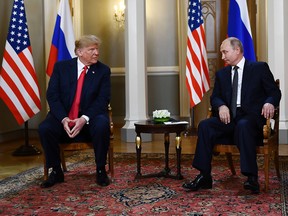 In this file photo taken on July 16, 2018 Russian President Vladimir Putin and U.S. President Donald Trump  attend a meeting in Helsinki, on July 16, 2018.