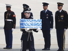 A soldier carries a casket containing the remains of a US soldier killed during the 1950-53 Korean War, after arriving from North Korea at Osan Air Base in Pyeongtaek on July 27, 2018.