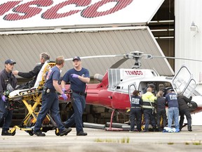 Emergency responders assist a passenger injured in a crash of a Taquan Air plane in mountainous terrain on Prince of Wales Island Tuesday, July 10, 2018, in Ketchikan, Alaska.