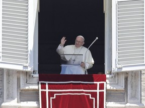 Pope Francis blesses the crowd as he recites the Angelus noon prayer from the window of his studio overlooking St.Peter's Square, at the Vatican, Sunday, July 1, 2018. Pope Francis has lamented intensified attacks in southern Syria, asking that people be spared more suffering.