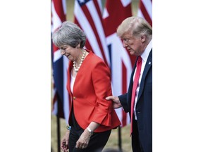 British Prime Minister Theresa May, left and U.S. President Donald Trump attend a joint press conference following their meeting at Chequers, in Buckinghamshire, England, Friday, July 13, 2018.