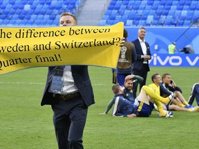 Sweden's Sebastian Larsson holds a banner to fans after winning the round of 16 match between Switzerland and Sweden at the 2018 soccer World Cup in the St. Petersburg Stadium, in St. Petersburg, Russia, Tuesday, July 3, 2018.