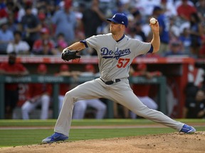Los Angeles Dodgers starting pitcher Alex Wood throws to the plate during the first inning of a baseball game against the Los Angeles Angels Sunday, July 8, 2018, in Anaheim, Calif.