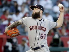 Houston Astros starting pitcher Dallas Keuchel throws against the Los Angeles Angels during the first inning of a baseball game in Anaheim, Calif., Friday, July 20, 2018.