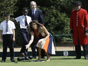 U.S. First Lady Melania Trump plays bowls she meets British military veterans known as "Chelsea Pensioners" at The Royal Hospital Chelsea in central London Friday, July 13, 2018.