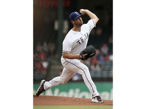 Texas Rangers starting pitcher Cole Hamels delivers against the Oakland Athletics during the first inning of a baseball game Monday, July 23, 2018, in Arlington, Texas.