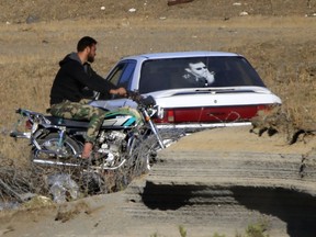 Syrian soldiers arrive to Syria's Quneitra border crossing between Syria and the Israeli-controlled Golan Heights, Thursday, July 26, 2018.