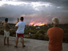 People watch a wildfire in the town of Rafina, near Athens, on July 23, 2018.