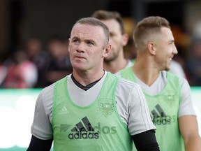 D.C. United forward Wayne Rooney, left, walks on the field before an MLS soccer match against the Vancouver Whitecaps at Audi Field, Saturday, July 14, 2018, in Washington.