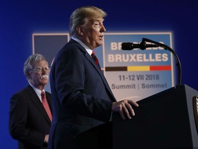 U.S. President Donald Trump speaks during a news conference before departing the NATO Summit in Brussels, Belgium, Thursday, July 12, 2018. On stage with Trump is National Security Adviser John Bolton.