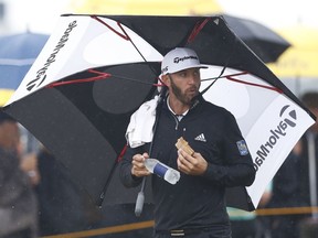 Dustin Johnson of the US eats a sandwich along the 9th fairway during the second round of the British Open Golf Championship in Carnoustie, Scotland, Friday July 20, 2018.