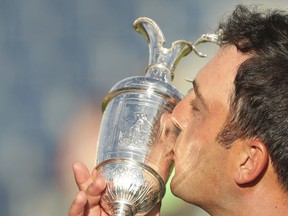 Francesco Molinari of Italy kisses the trophy after winning the British Open Golf Championship in Carnoustie, Scotland, Sunday July 22, 2018.