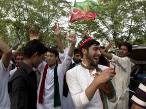 Supporters of politician Imran Khan, chief of the Pakistan Tehreek-e-Insaf party, dance to celebrate the victory of their party candidate, outside their leader's home in Islamabad, Pakistan, Thursday, July 26, 2018. Khan declared victory Thursday for his party in the country's general elections, promising a "new" Pakistan following a vote that was marred by allegations of fraud and militant violence.