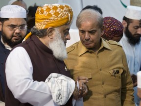 Maulana Fazlur Rehman, left, head of Pakistani religious parties alliance talks to Shahbaz Sharif, leader of Pakistan Muslim League and brother of ousted prime minister Nawaz Sharif after the All Parties Conference (APC) in Islamabad, Pakistan, Friday, July 27, 2018. Rehman told that APC has rejected the results of the July 25 general election result. With Pakistani election officials declaring the party of Imran Khan to be the winner of parliamentary balloting, the former cricket star turned Friday to forming a coalition government, since the party did not get an outright majority.