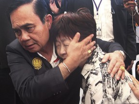 Thailand Prime Minister Prayuth Chan-ocha consoles a relative of a victim in the last week's boat accident, Monday, July 9, 2018, on the tourist island of Phuket, Thailand. The death toll from Thursday's boat accident climbed to dozens, in Thailand's biggest tourist-related disaster in years. The boat, with 105 people, including 93 tourists, capsized and sank after it was hit by 5-meter (16-foot) waves. (AP Photo)