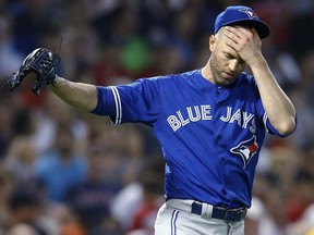 Toronto Blue Jays' starter J.A. Happ reacts while pitching during the fourth inning against the Red Sox in Boston on Thursday night.