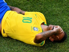 Brazil forward Neymar goes down injured against Mexico at the World Cup on July 2.