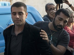 Brazilian surgeon Dr. Denis Cesar Barros Furtado is escorted by police after his arrest in Rio de Janeiro, Brazil, Thursday, July 19, 2018.