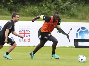 Martin Compston, left and Usain Bolt take part in the World XI team's training session for Soccer Aid for UNICEF at Motspur Park, in London, Thursday June 7, 2018.