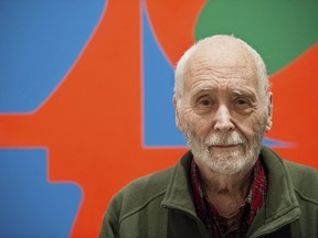 FILE - In this Sept. 24, 2013, file photo, artist Robert Indiana, known for his LOVE artwork, poses in front of that painting at New York's Whitney Museum of American Art. A spokesman told The Associated Press on Friday, July 20, 2018, that a medical examiner has been unable to determine the cause of Indiana's death, but that the death was not suspicious. Indiana died May 19, 2018, at age 89 at his Vinalhaven Island home off the coast of Maine.