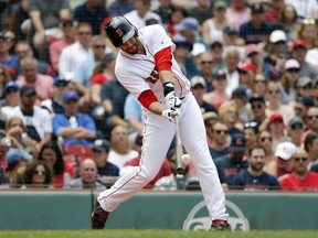 Boston Red Sox's J.D. Martinez connects on a solo home run against the Toronto Blue Jays during the fourth inning of a baseball game Saturday, July 14, 2018, in Boston.